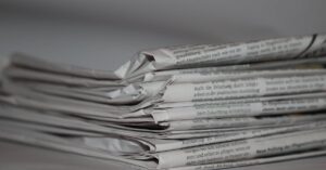 A close-up image of folded newspapers, perfect for news or journalism themes.